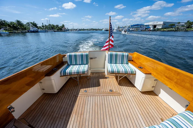 Lionheart Yacht Photos Pics Hinckley Talaria 44 FB 2008 yacht deck with striped seating, cruising on a sunny day.