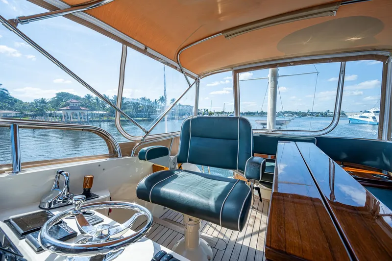 Lionheart Yacht Photos Pics 2008 Hinckley Talaria 44 FB yacht interior with steering wheel and seating, overlooking water.