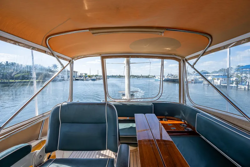 Lionheart Yacht Photos Pics 2008 Hinckley Talaria 44 FB yacht interior with waterfront view, featuring elegant seating and wooden table.