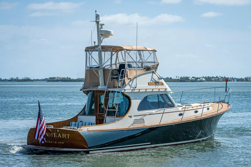 Lionheart Yacht Photos Pics 2008 Hinckley Talaria 44 FB yacht cruising on calm waters with clear skies.
