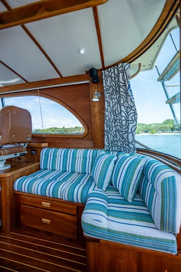 Lionheart Yacht Photos Pics Interior of 2008 Hinckley Talaria 44 FB with striped seating and wooden accents.