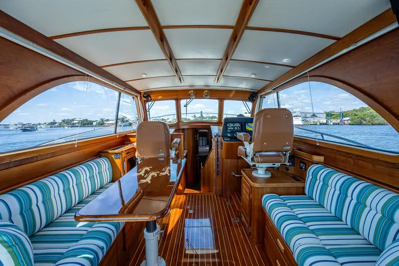 Lionheart Yacht Photos Pics Luxurious 2008 Hinckley Talaria 44 FB yacht interior with striped seating and wooden finishes.