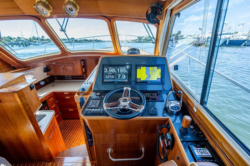 Lionheart Yacht Photos Pics Helm of 2008 Hinckley Talaria 44 FB yacht with navigation screens and wooden interior.