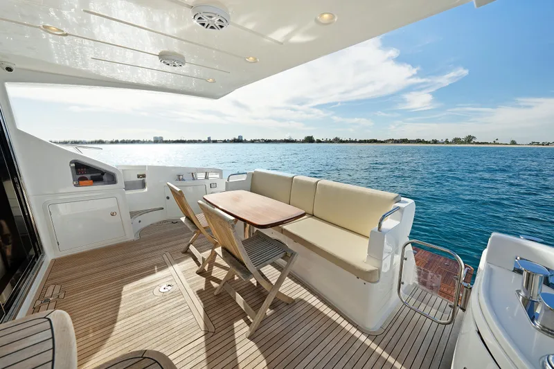 Acciaio Blu Yacht Photos Pics 2017 Azimut 60 Flybridge yacht deck with seating, overlooking serene blue waters.