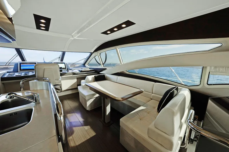 Acciaio Blu Yacht Photos Pics Luxurious interior of a 2017 Azimut 60 Flybridge yacht with modern seating and ocean view.