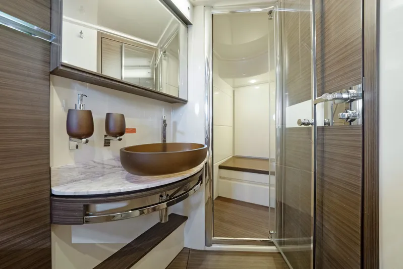 Acciaio Blu Yacht Photos Pics Luxurious bathroom in 2017 Azimut 60 Flybridge yacht with modern fixtures and wood accents.