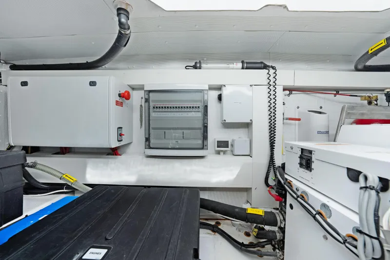 Acciaio Blu Yacht Photos Pics Engine room of a 2017 Azimut 60 Flybridge yacht, showcasing electrical panels and equipment.