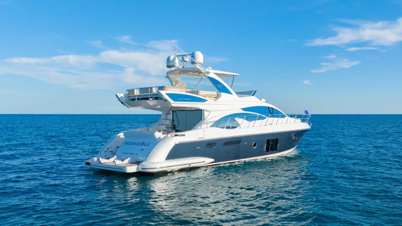 Acciaio Blu Yacht Photos Pics 2017 Azimut 60 Flybridge yacht cruising on open sea under clear blue sky.