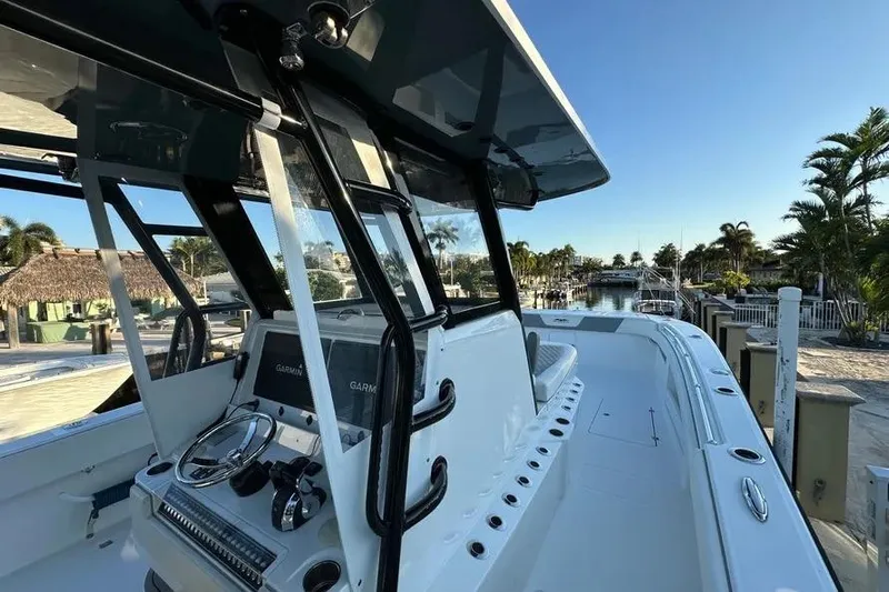  Yacht Photos Pics 2022 Invincible 35 Catamaran with modern helm, docked in a sunny marina.