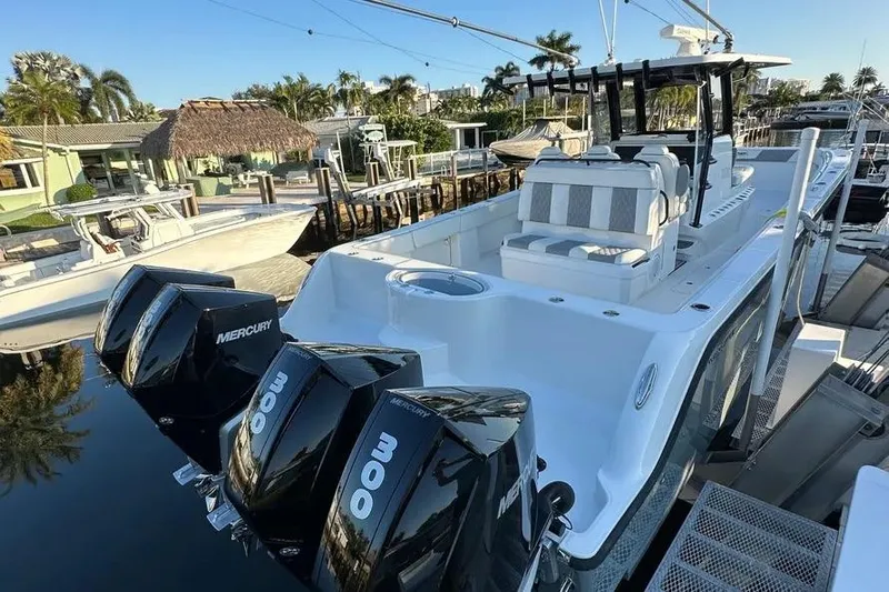  Yacht Photos Pics 2022 Invincible 35 Catamaran with triple Mercury engines docked at marina.