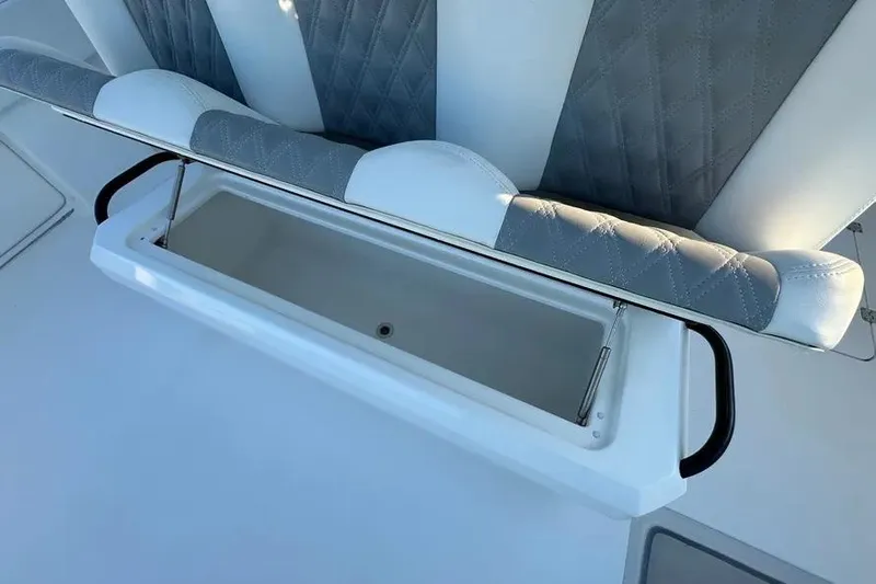  Yacht Photos Pics 2022 Invincible 35 Catamaran seat with storage compartment open, showcasing luxury design.