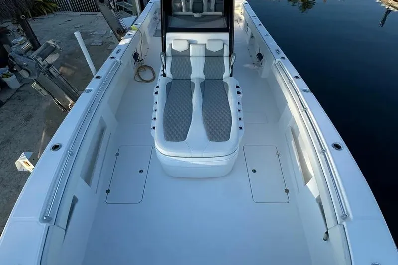  Yacht Photos Pics 2022 Invincible 35 Catamaran with spacious deck and comfortable seating, docked by calm water.