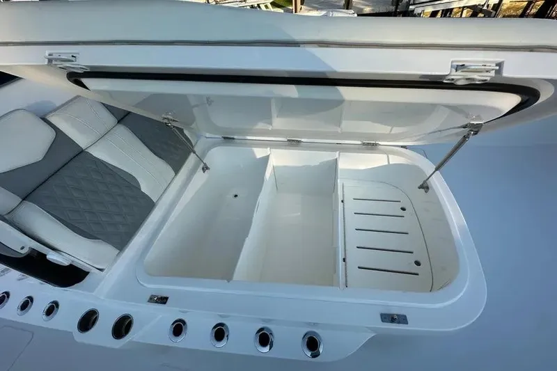  Yacht Photos Pics Open storage compartment on 2022 Invincible 35 Catamaran with cushioned seating.
