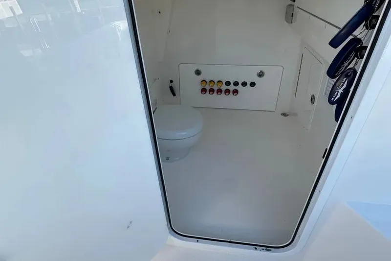  Yacht Photos Pics 2022 Invincible 35 Catamaran interior with toilet and control panel.