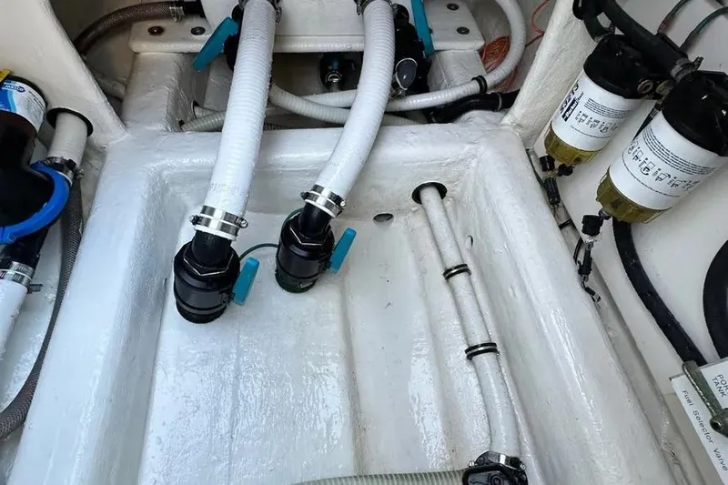  Yacht Photos Pics Engine compartment of 2022 Invincible 35 Catamaran with hoses and filters visible.