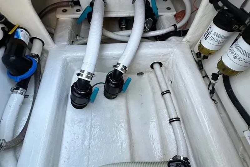  Yacht Photos Pics Engine compartment of 2022 Invincible 35 Catamaran, showcasing hoses and filters.