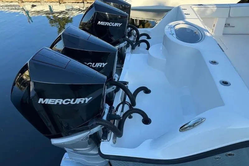  Yacht Photos Pics Triple Mercury engines on 2022 Invincible 35 Catamaran, docked by the water.