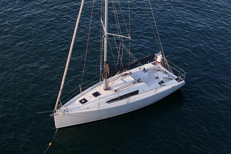 From Away Yacht Photos Pics 2017 Jeanneau SunFast 3200 sailboat on calm water, aerial view.