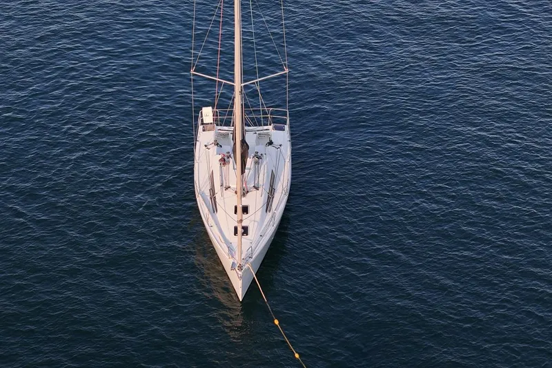 From Away Yacht Photos Pics Aerial view of 2017 Jeanneau SunFast 3200 sailboat on calm water.