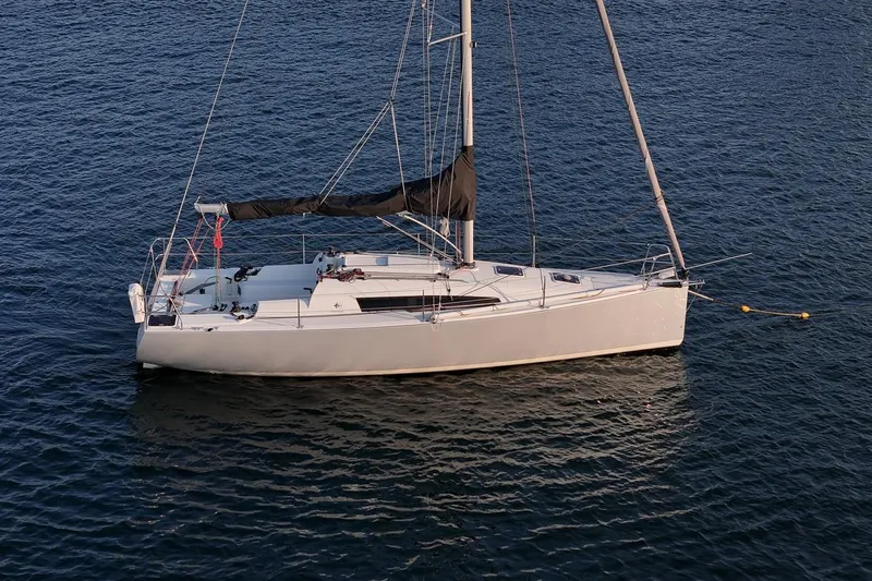 From Away Yacht Photos Pics 2017 Jeanneau SunFast 3200 sailboat on calm water, side view.