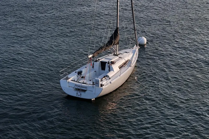 From Away Yacht Photos Pics 2017 Jeanneau SunFast 3200 sailboat moored on calm water.