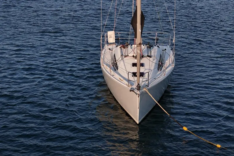 From Away Yacht Photos Pics 2017 Jeanneau SunFast 3200 sailboat moored on calm blue water.
