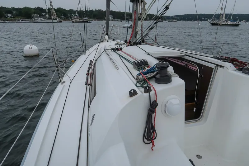 From Away Yacht Photos Pics 2017 Jeanneau SunFast 3200 sailboat deck with rigging, moored in a calm harbor.