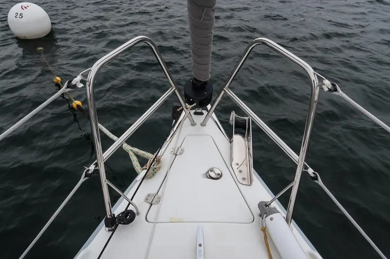 From Away Yacht Photos Pics Bow of 2017 Jeanneau SunFast 3200 sailboat with mooring buoy in water.