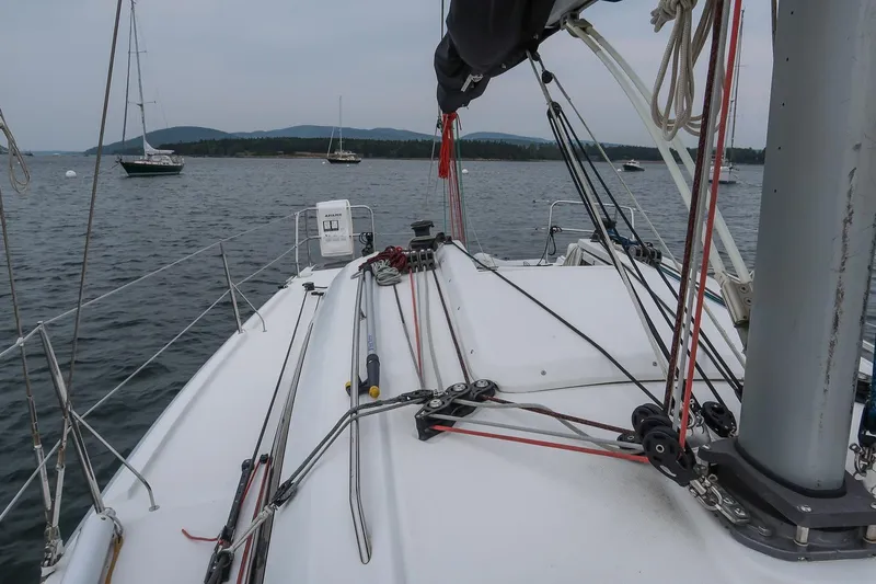 From Away Yacht Photos Pics 2017 Jeanneau SunFast 3200 sailboat deck with rigging, anchored in calm waters.