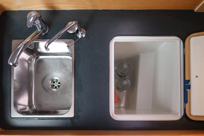 From Away Yacht Photos Pics Stainless steel sink and storage compartment in 2017 Jeanneau SunFast 3200 yacht kitchen.