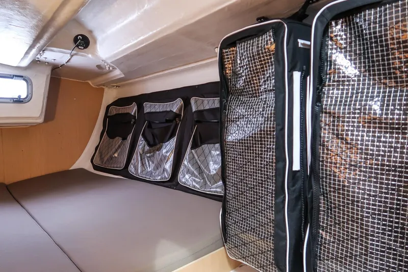 From Away Yacht Photos Pics Interior cabin of 2017 Jeanneau SunFast 3200 with storage compartments and bedding.