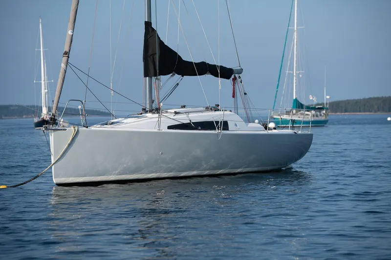 From Away Yacht Photos Pics 2017 Jeanneau SunFast 3200 sailboat anchored on calm water.