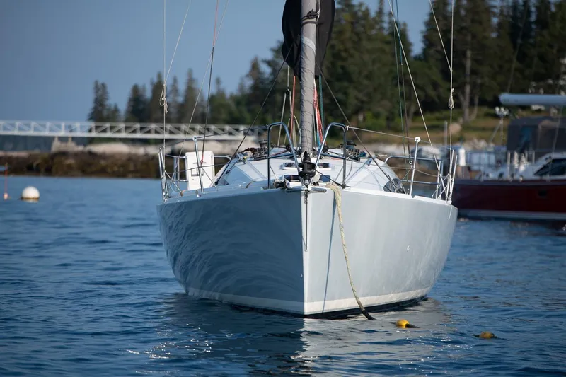 From Away Yacht Photos Pics 2017 Jeanneau SunFast 3200 sailboat on calm water with forested shoreline background.