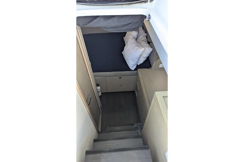 Wanderlust Yacht Photos Pics Interior cabin of 2020 Fountaine Pajot Saona 47 catamaran, featuring a cozy bed and storage.