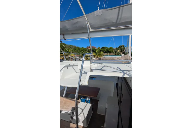 Wanderlust Yacht Photos Pics Fountaine Pajot Saona 47 catamaran, 2020 model, featuring outdoor seating and scenic marina view.
