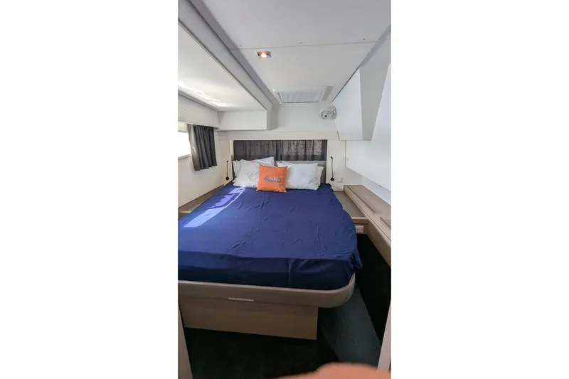 Wanderlust Yacht Photos Pics Bedroom interior of 2020 Fountaine Pajot Saona 47 catamaran with blue bedding and modern design.