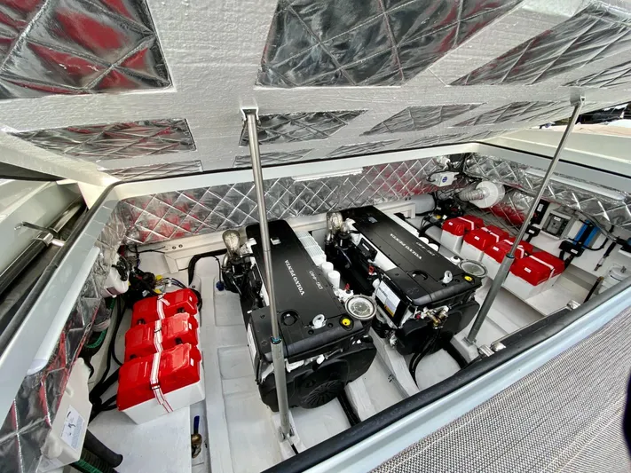 Seayou Yacht Photos Pics Engine compartment of 2022 SACS Strider 15 with dual engines and red battery packs.
