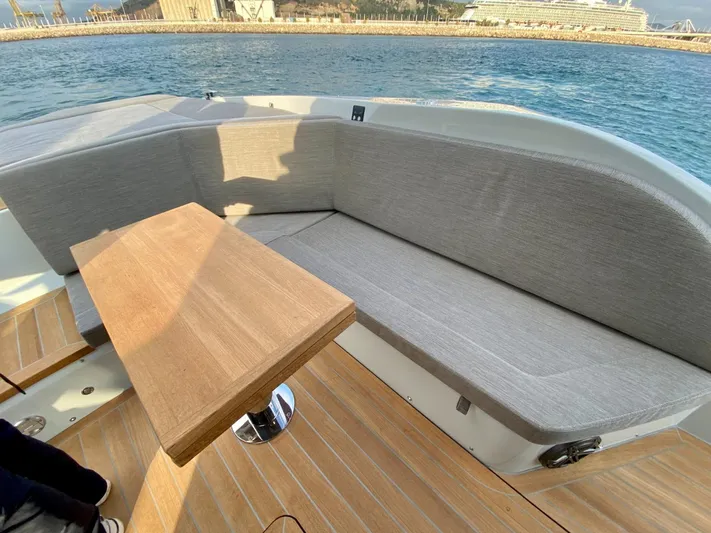 Seayou Yacht Photos Pics Luxurious seating area on 2022 SACS Strider 15 yacht with wooden table, ocean view.
