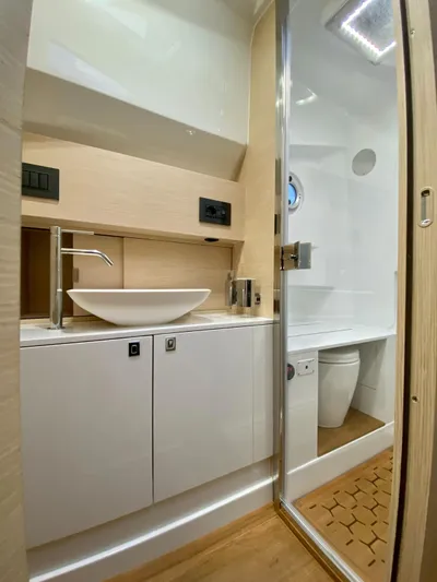 Seayou Yacht Photos Pics Modern bathroom in 2022 SACS Strider 15 yacht with sleek fixtures and wooden accents.