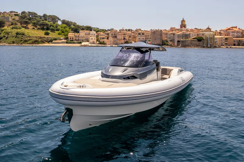 Seayou Yacht Photos Pics 2022 SACS Strider 15 boat on calm water near coastal town.