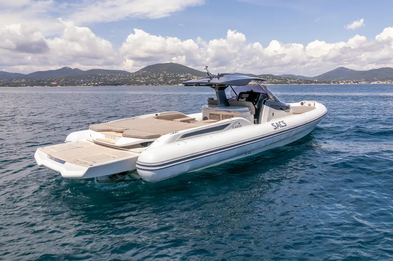 Seayou Yacht Photos Pics 2022 SACS Strider 15 luxury boat on calm sea with scenic mountain backdrop.