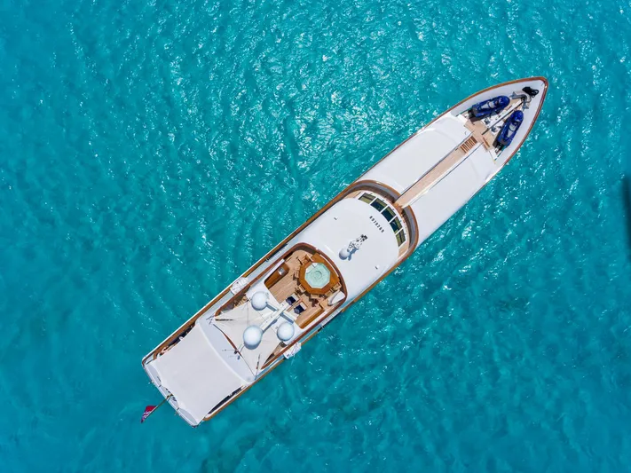 Lady J Yacht Photos Pics Aerial view of 1997 Palmer Johnson motor yacht on turquoise water.