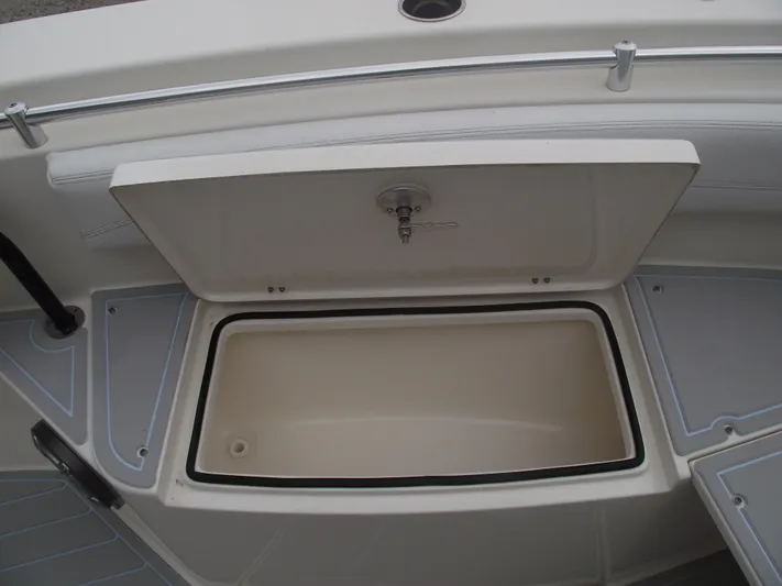  Yacht Photos Pics 2021 Cobia 301 Center Console storage compartment with open lid, showcasing interior space.