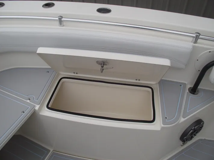  Yacht Photos Pics 2021 Cobia 301 Center Console boat storage compartment open, showcasing interior space.
