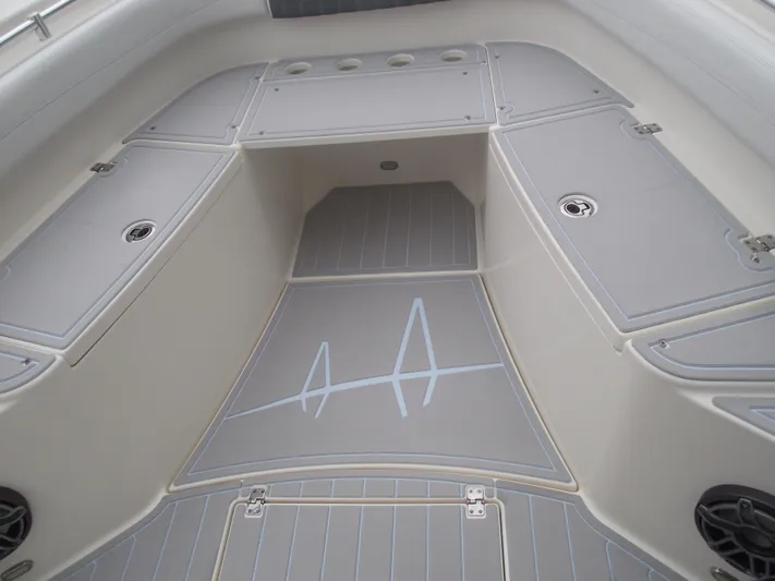  Yacht Photos Pics 2021 Cobia 301 Center Console boat interior with gray deck and storage compartments.