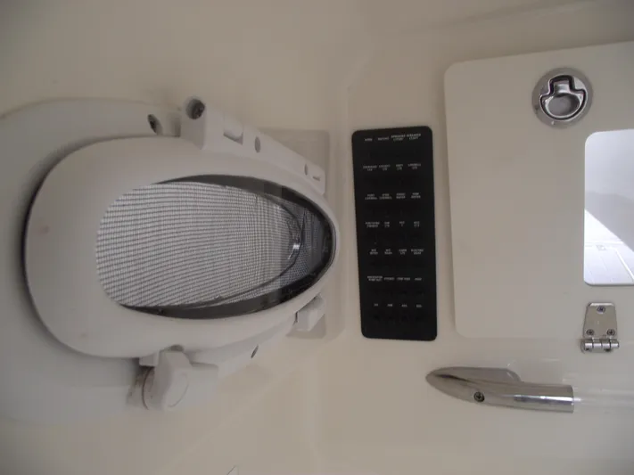  Yacht Photos Pics 2021 Cobia 301 Center Console interior detail with control panel and hatch.