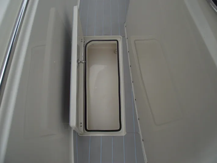  Yacht Photos Pics Storage compartment on 2021 Cobia 301 Center Console boat interior.
