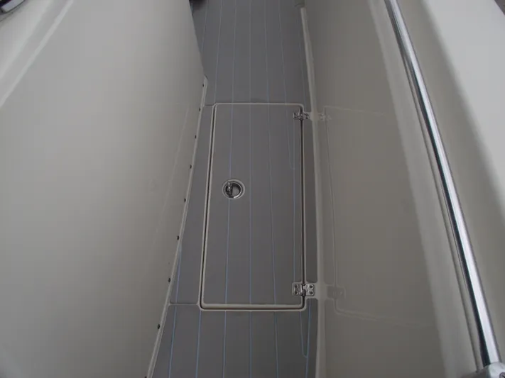  Yacht Photos Pics 2021 Cobia 301 Center Console boat deck with storage hatch and railing.
