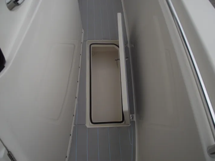  Yacht Photos Pics 2021 Cobia 301 Center Console boat storage compartment with open lid.