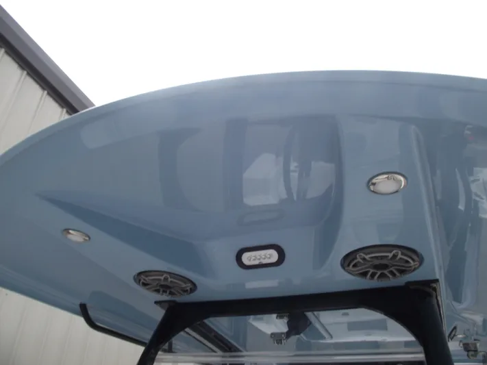  Yacht Photos Pics 2021 Cobia 301 Center Console boat's blue T-top with speakers and lights.
